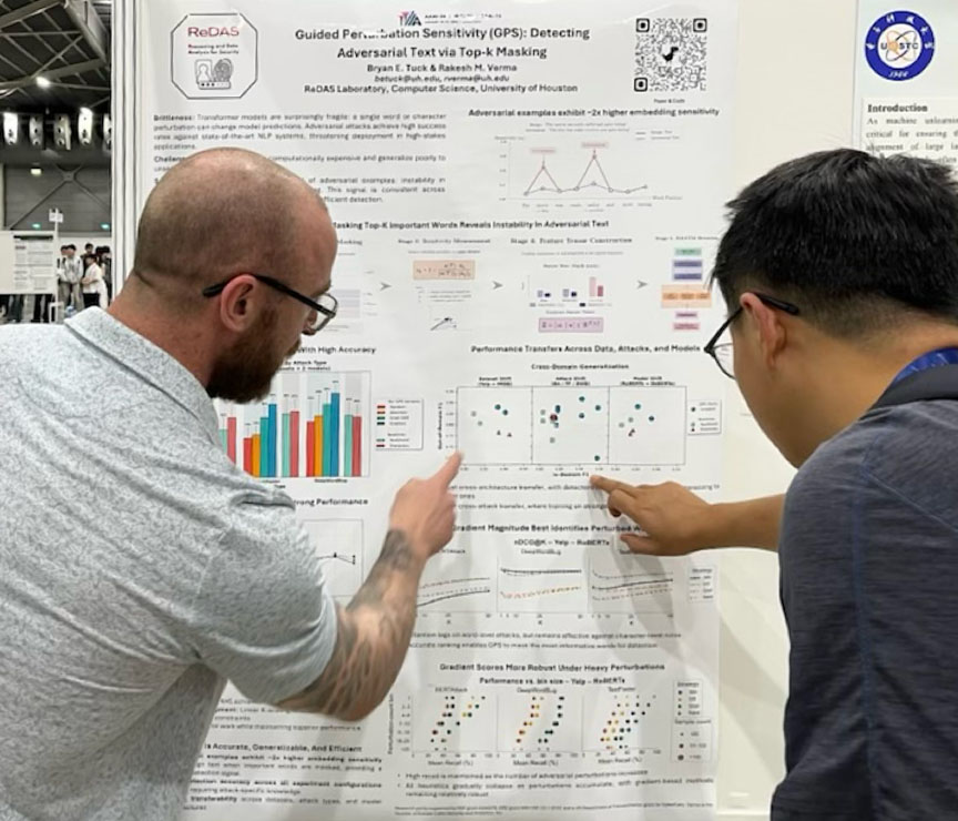 Bryan Tuck discusses his poster with an onlooker.