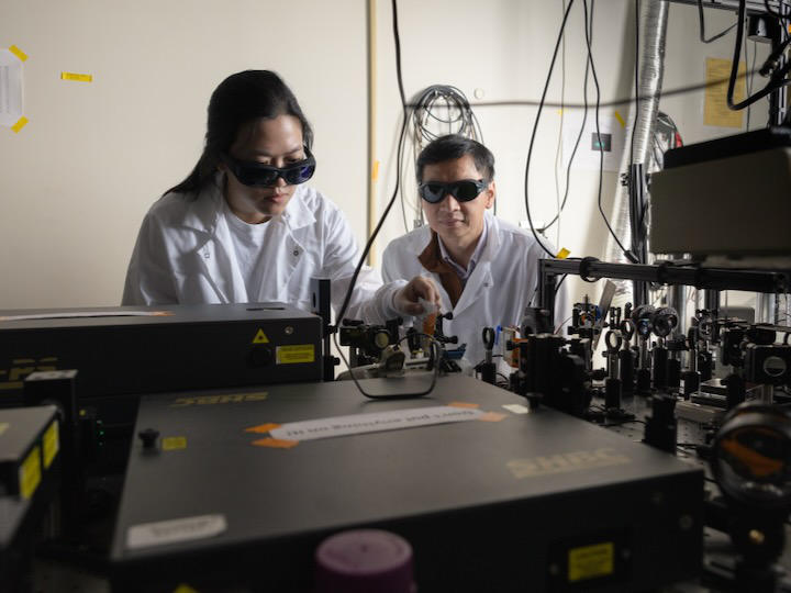 Ph.D. candidate Wenkai Chen aligns a laser with the assistance of Associate Professor Tai-Yen Chen.
