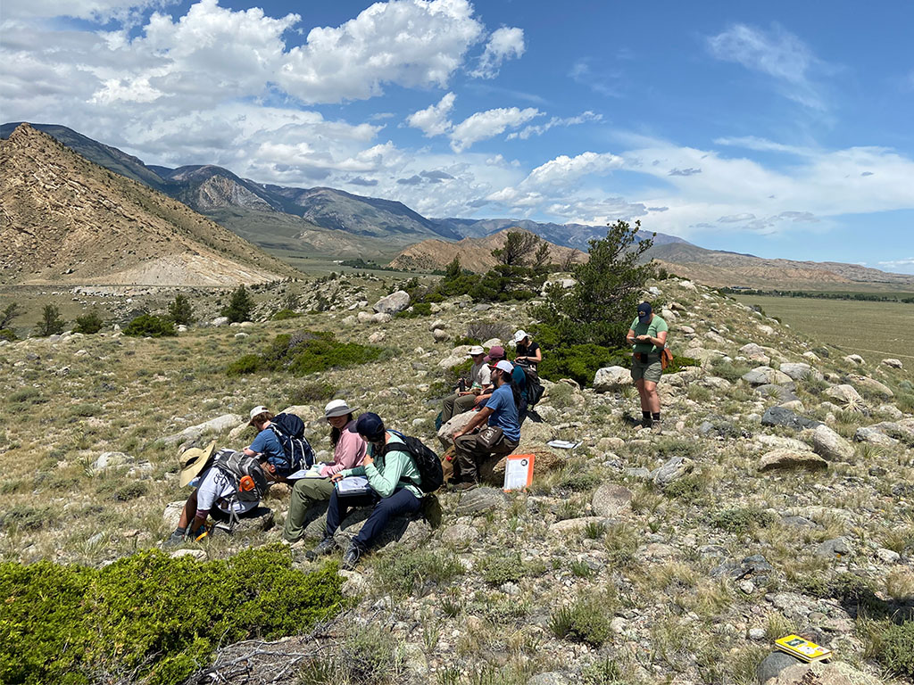 Students take a quick lunch break on top of a terminal moraine. Photo credit: Jack McLaughlin, TA