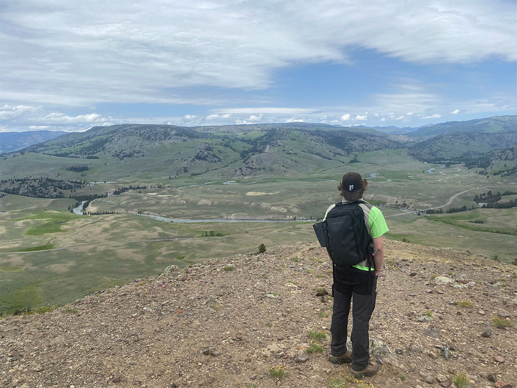 TA Abe Masaryk ponders the beauty of the natural world from the top of Specimen Ridge. Photo credit: Jack McLaughlin, TA