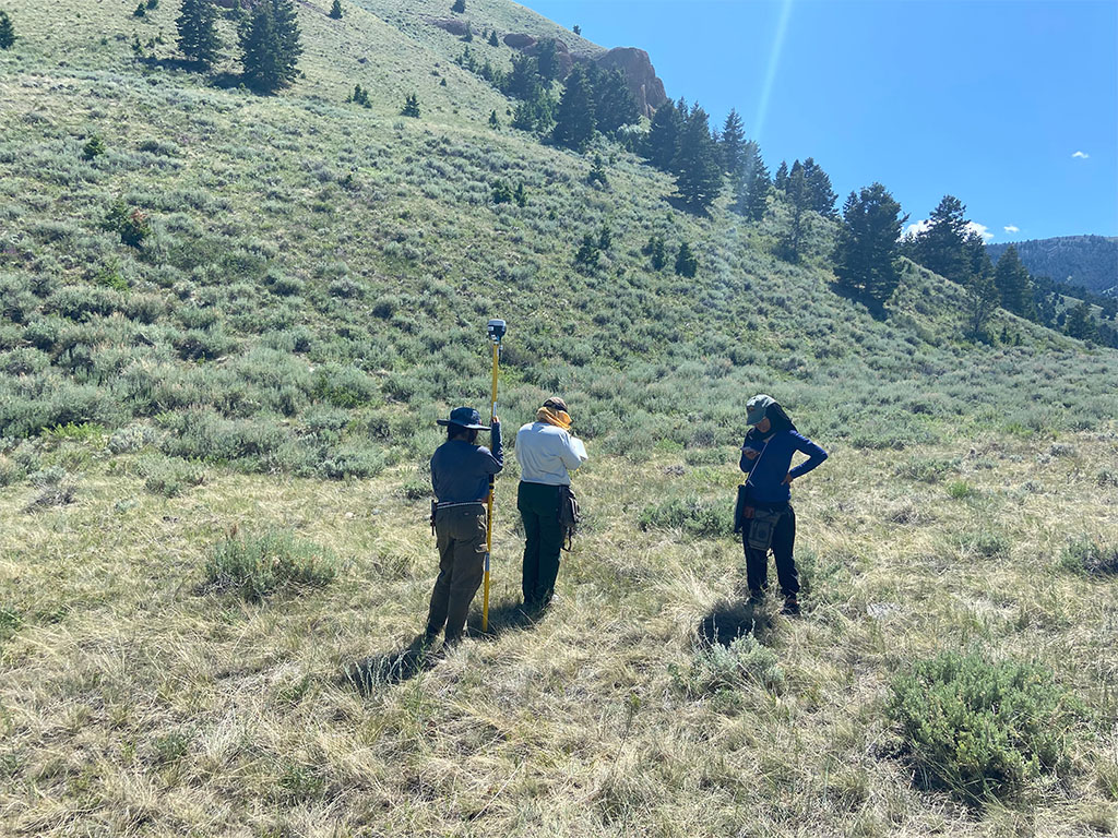 Students using GPS equipment to make a fault scarp profile. Photo credit: Jack McLaughlin, TA