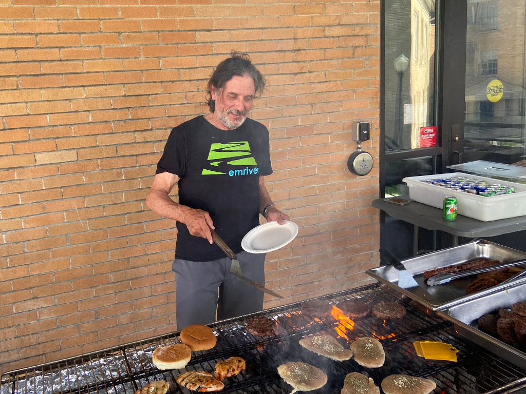 Professor John Weber donning the mantle of grill master to prepare a variety of meats. Photo credit: Jack McLaughlin, TA