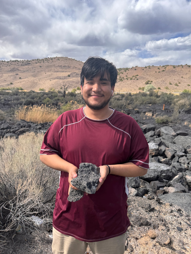 Student holding basalt samples from the Carrizozo volcanic field.