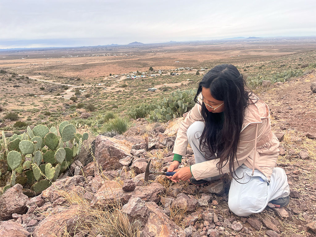 Student breaks open rock above campsite. Photo credit: Brandee Carlson