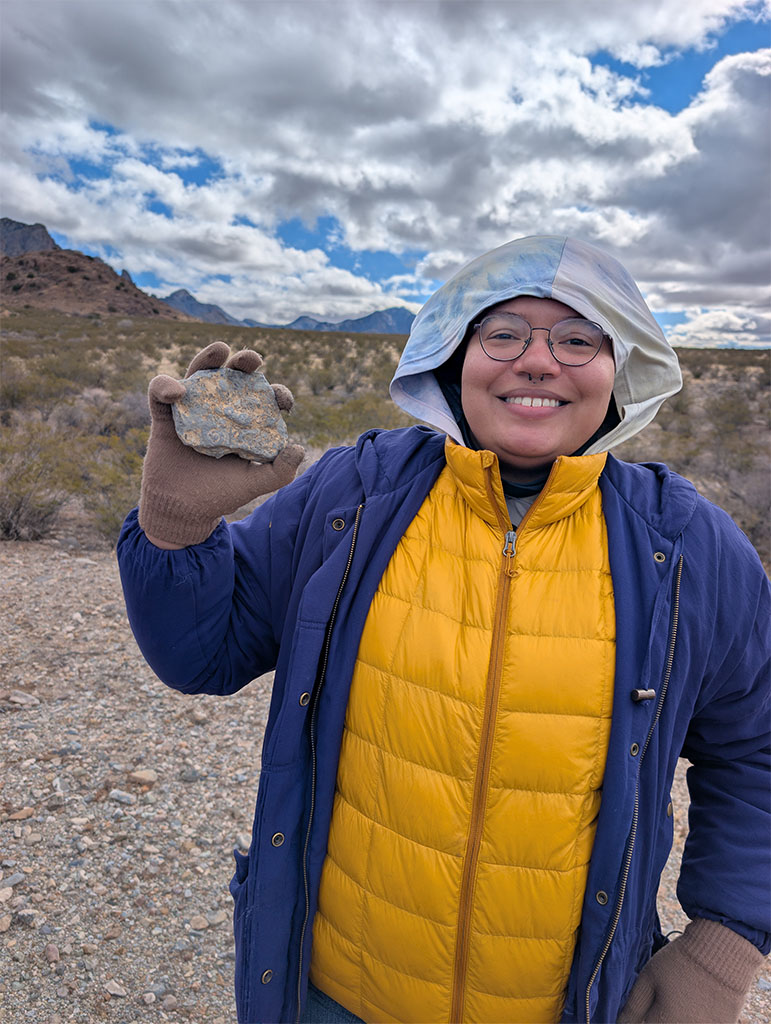 Undergraduate student stoked to find a fossil! Photo credit: Brian Dang