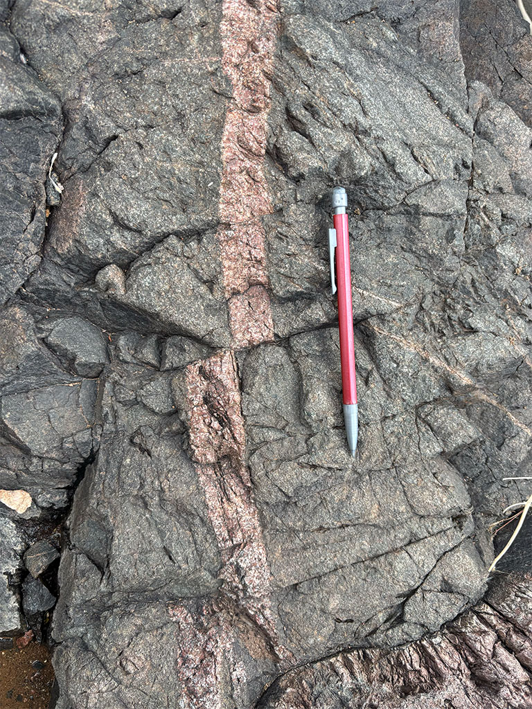 Faulted rock with volcanic intrusion. Pencil for scale. Photo credit: Megan Kroeger