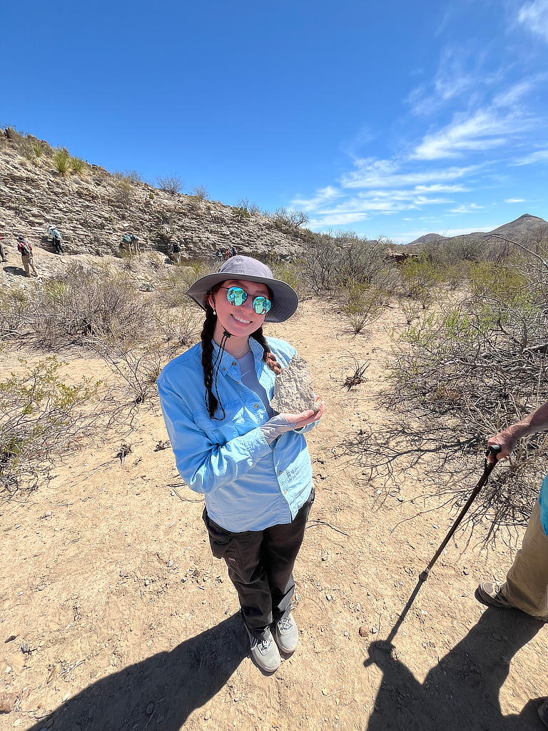 Photo Credit: TA Michael Daniel - Student Cassie Salinas is very satisfied with this fossiliferous piece of float she found at the base of the outcrop.