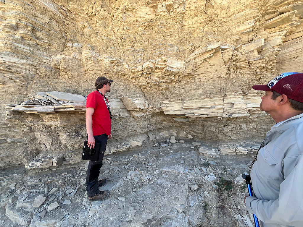 Photo Credit: TA Michael Daniel - Teaching assistant Abe Masaryk and professor Dr. Mike Murphy contemplate and discuss observations concerning the extensional features seen at this outcrop.