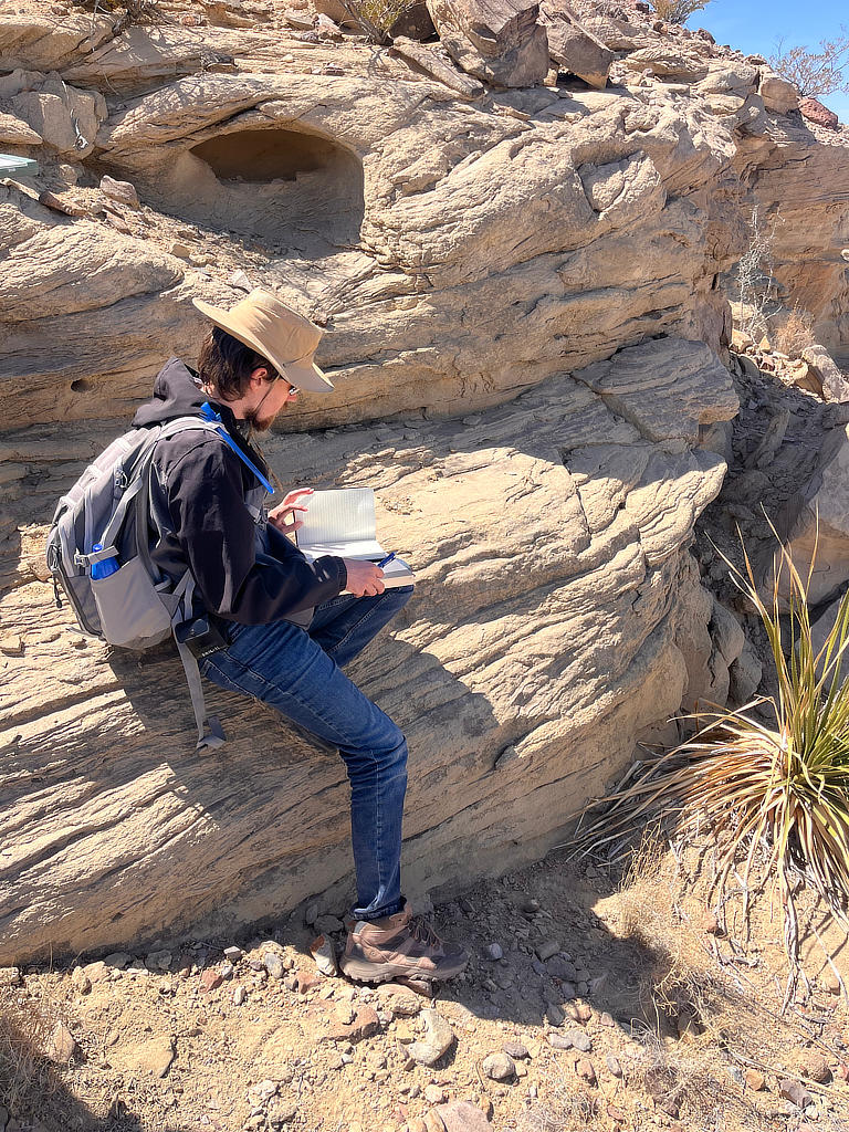 Photo Credit: TA Abe Okayli Masryk - Student Dylan Hipps, deep in thought while he observes this outcrop.