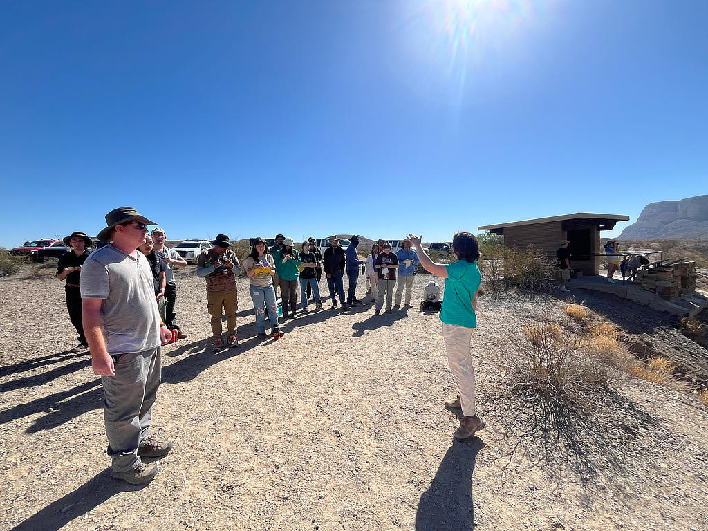 Photo Credit: TA Michael Daniel - Graduate student Syd Lineberry leads the students through an explanation of how Santa Elena Canyon formed and its stratigraphy while the students sketch what they can observe.