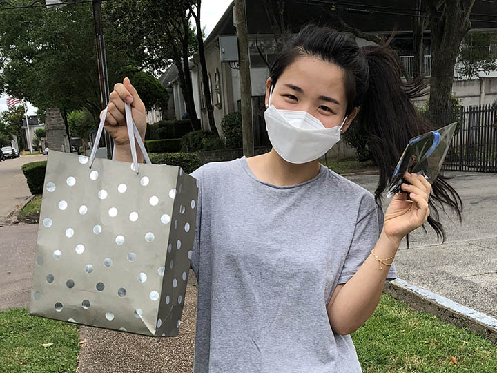 student holds off homemade masks