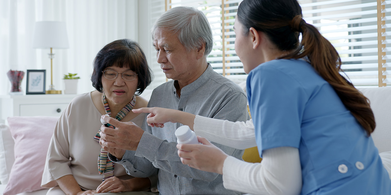 health care provider reviewing medicines with an older adult couple