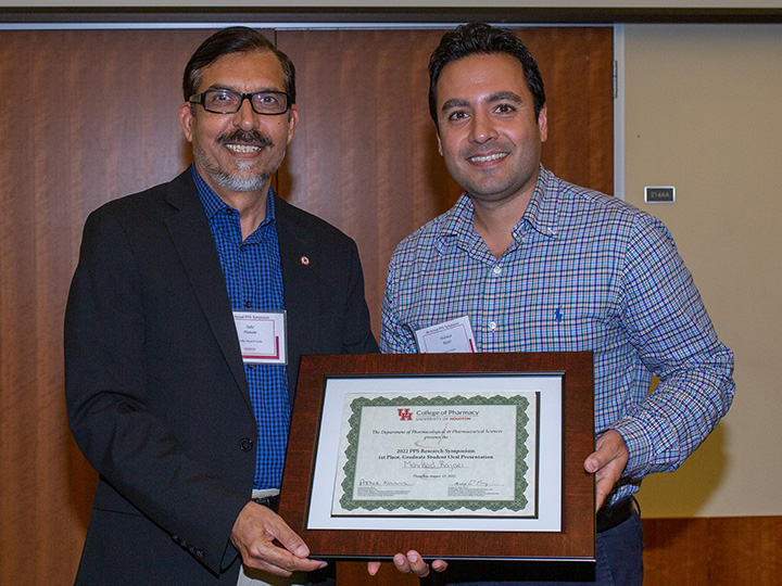 Mehrdad Rajaei receiving his first-place certificate from Tahir Hussain