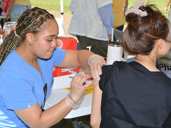 Moorer provides immunization to student