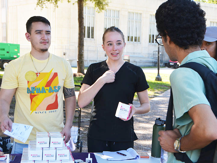 Briggs and Garcia explain the use of naloxone to student