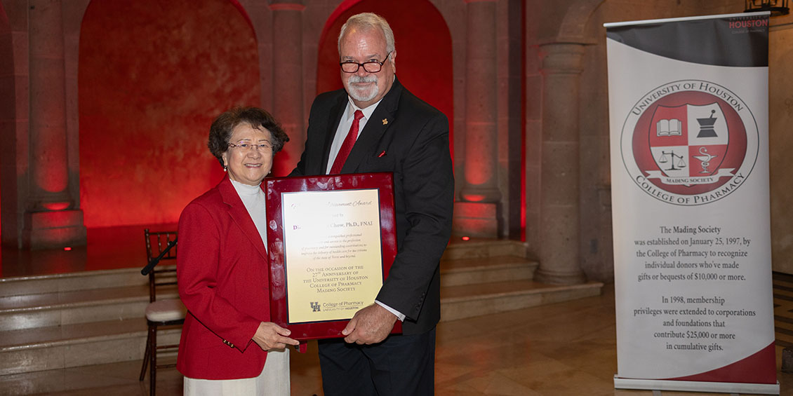 Chow and Pritchard holding plaque