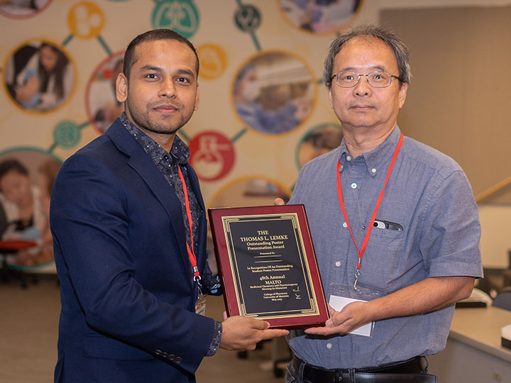 Islam and Park with award