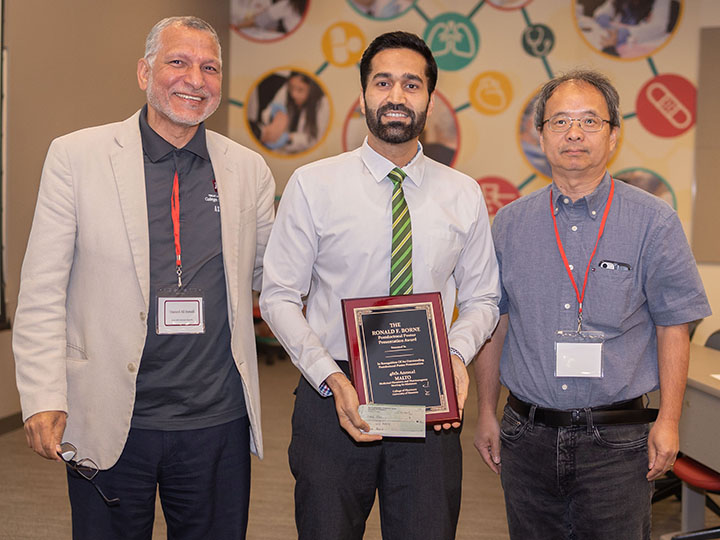 Ali, Khan and Li with award