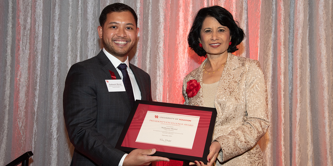 Mortel being presented award by UH President Renu Khator