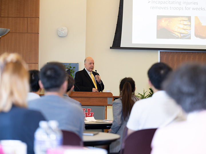 Sinko at podium in front of audience
