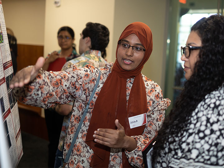 Nusrat talking with attendee