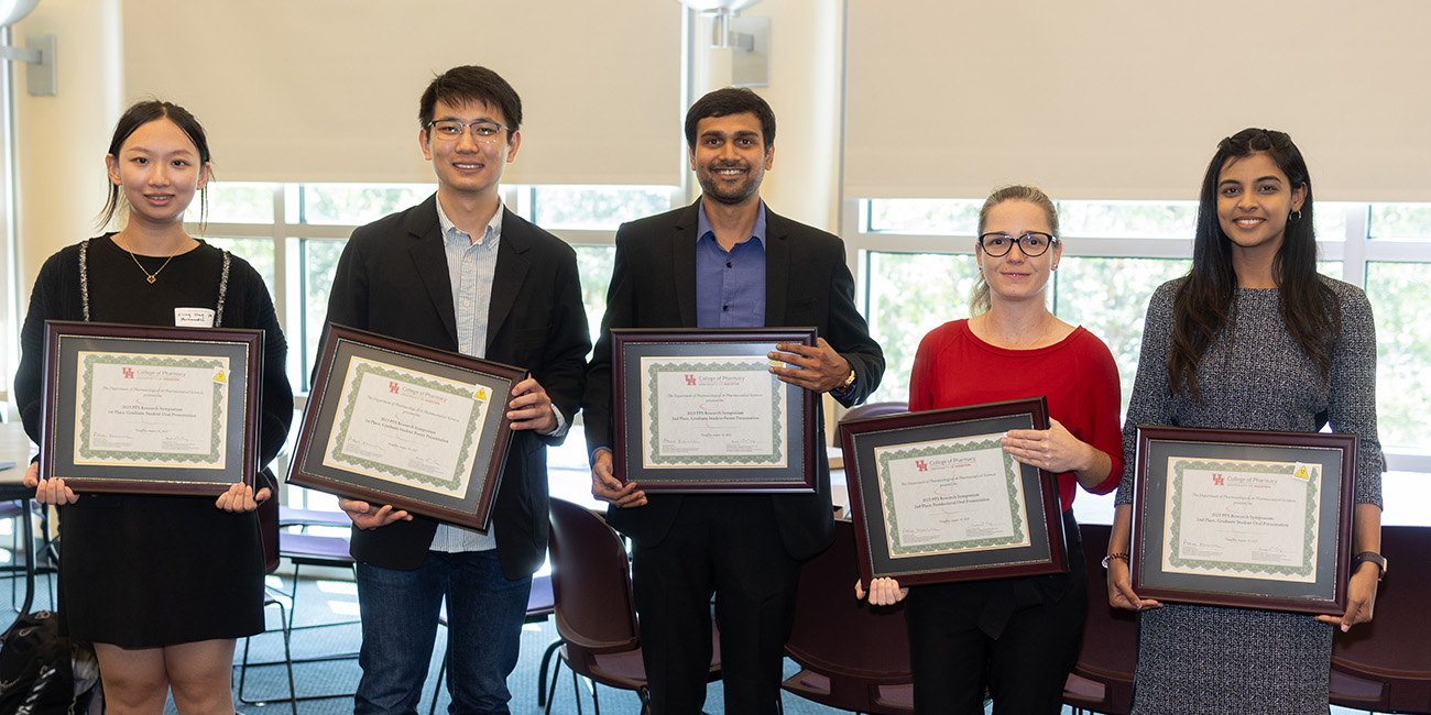 award recipients holding their framed certificates
