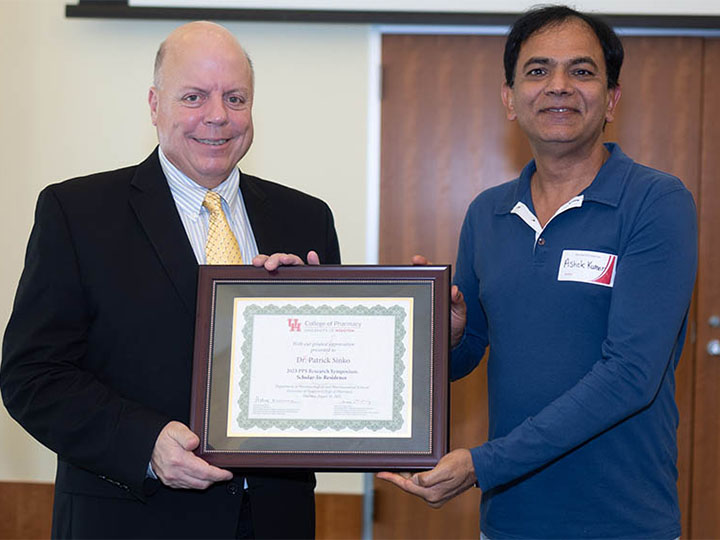 Sinko and Kumar with framed certificate