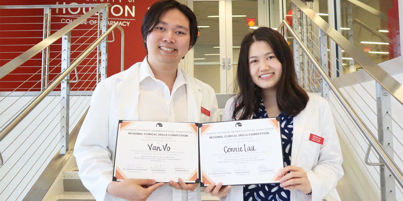 Lau and Vo holding certificates