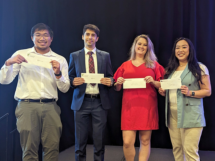 scholarship recipients holding check