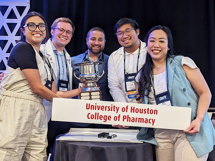 Self-Care team and alumnus Ahmad with trophy