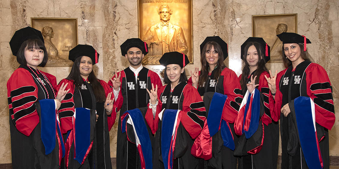 PhD graduates in cap and gown
