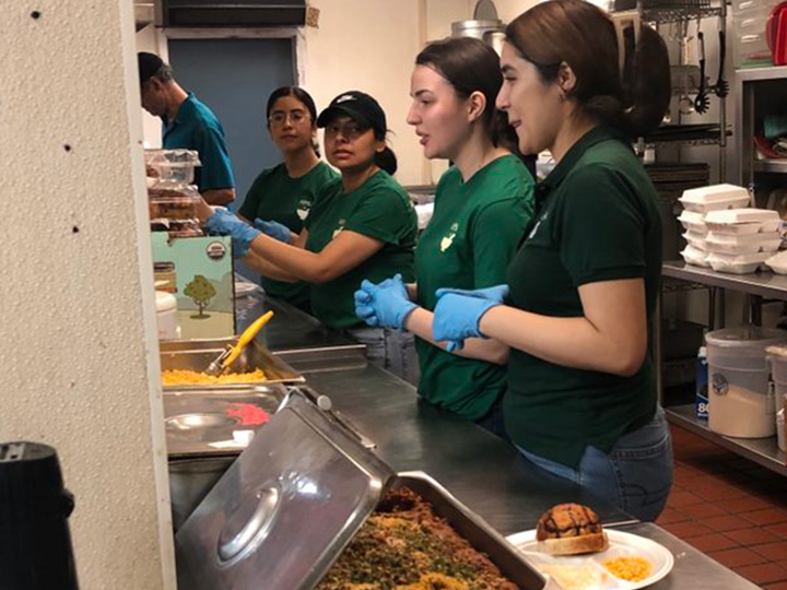 HPSA members prepare plates at food kitchen