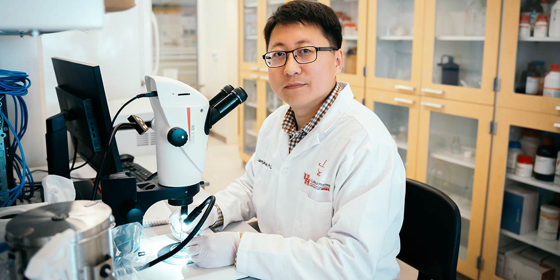 Miao at bench in lab