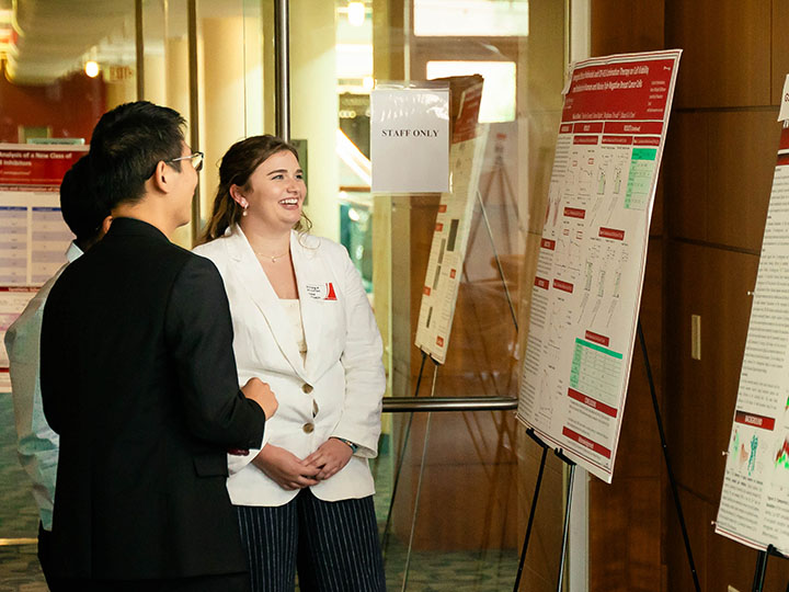 Ph.D. student Stillman explains project to attendees