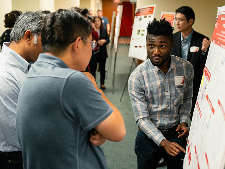 Ph.D. student Charles Owusu Ansah explains his project to attendees