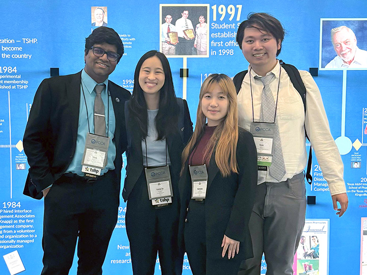 Singh, Nguyen, Ai and Vo in front of TSHP history display