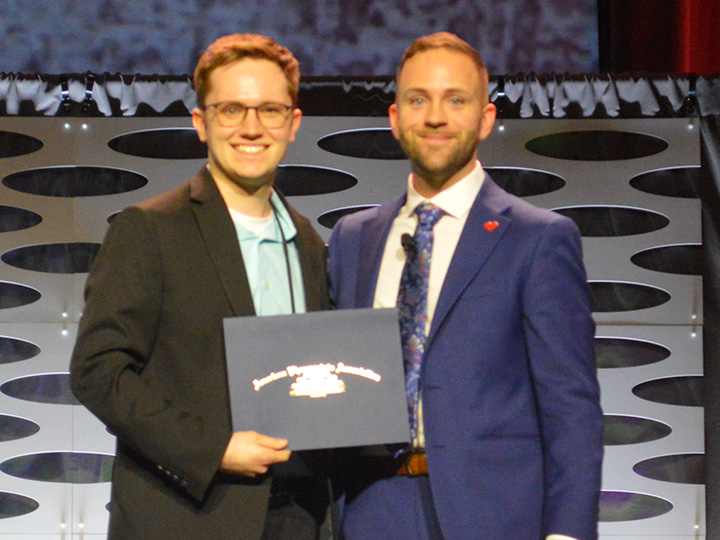 Adam receiving award from 