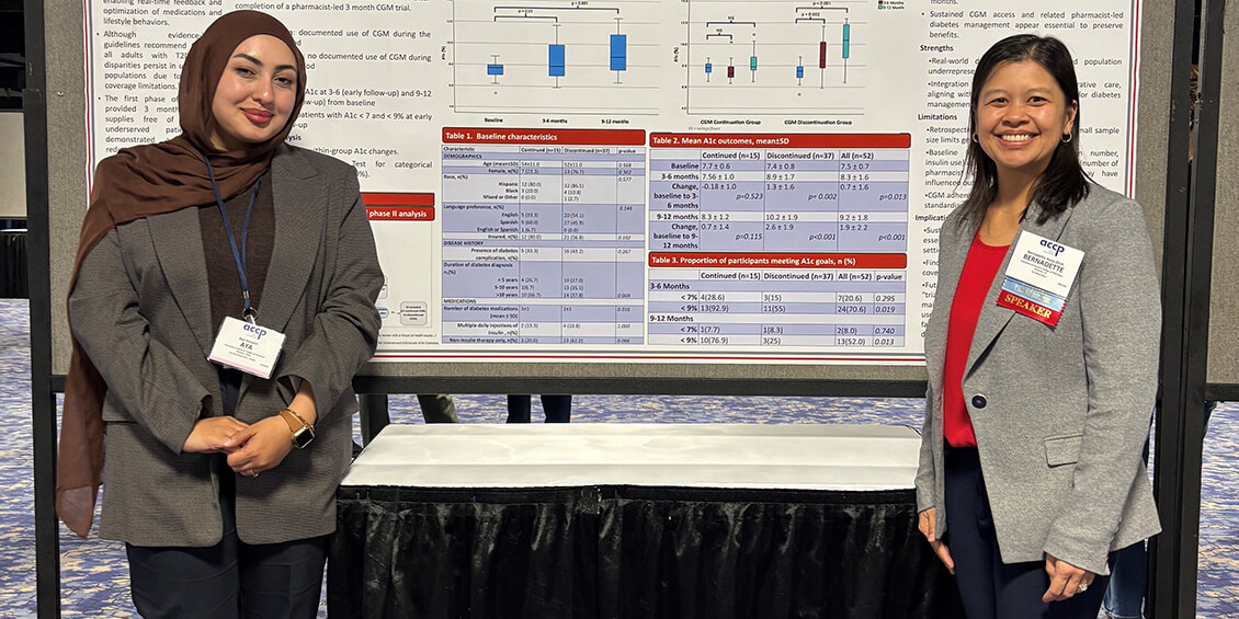 Hussein and Asias-Dinh standing next to poster