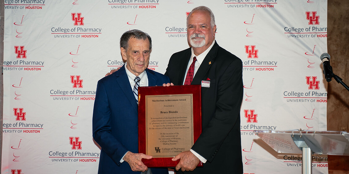 Bruce Biundo receives Meritorious Achievement Award from Dean Pritchard