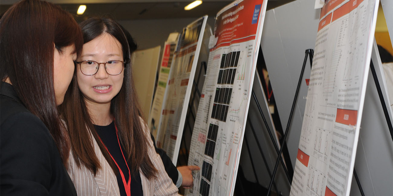 CTRS student presenter discusses poster with attendee