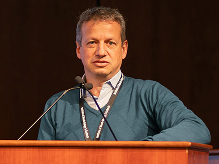 sandri speaking at podium