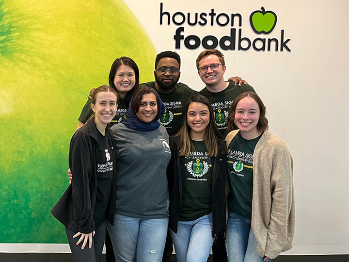 PLS members in front of Houston Food Bank mural
