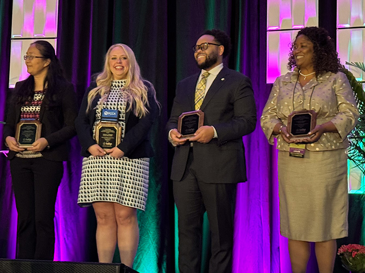 Blackwell and other TSHP Fellows hold plaques on stage