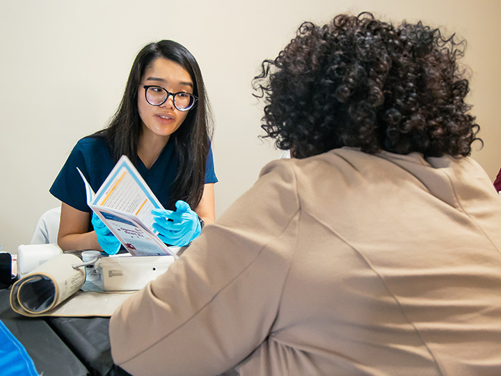 Han Van with a patient at health fair