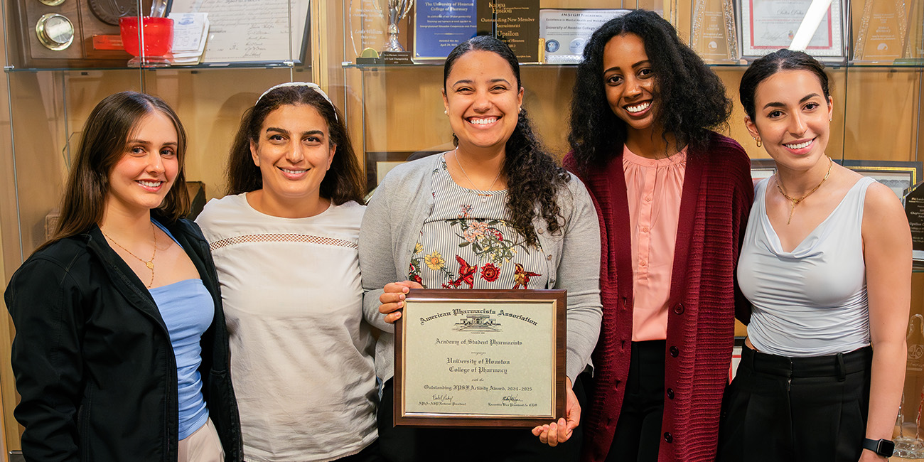 APHA-ASP IPSF 2024-25 Leadership Team in front of awards case