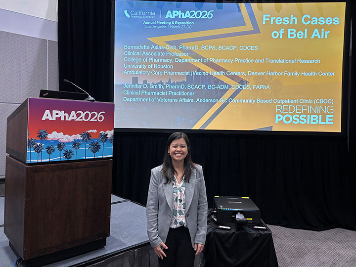 Bernadette Asias-Dinh next to the presentation stage at APhA 2026