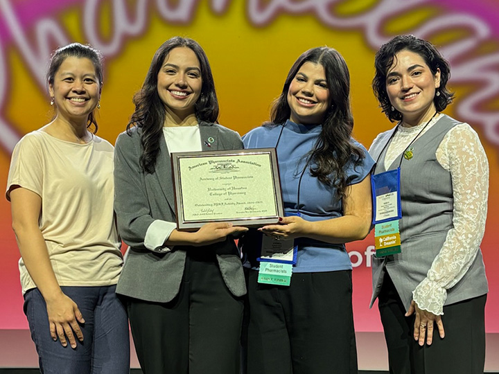 APHA-ASP team accept the Outstanding IPSF Activity Award on stage at APhA 2026