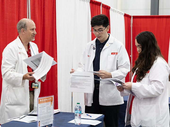 wallace and students review immunization guidelines