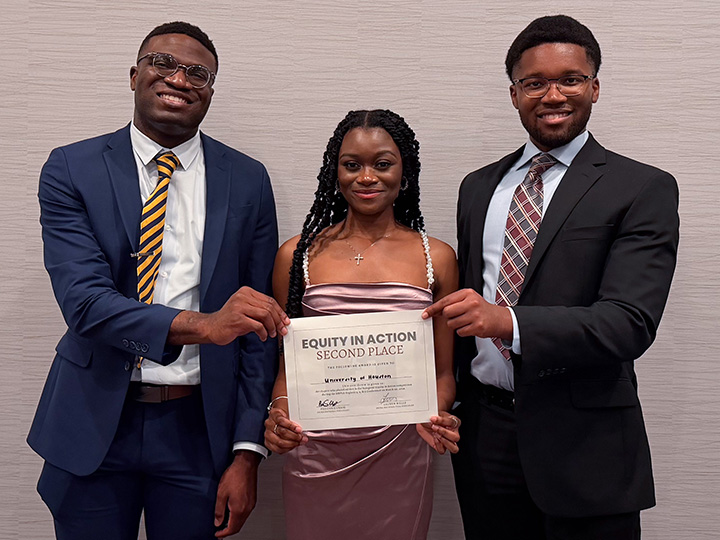 Equity in Action team members Umah, Nicholas and Crichlow with certificate