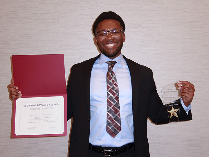 Crichlow with award and certificate